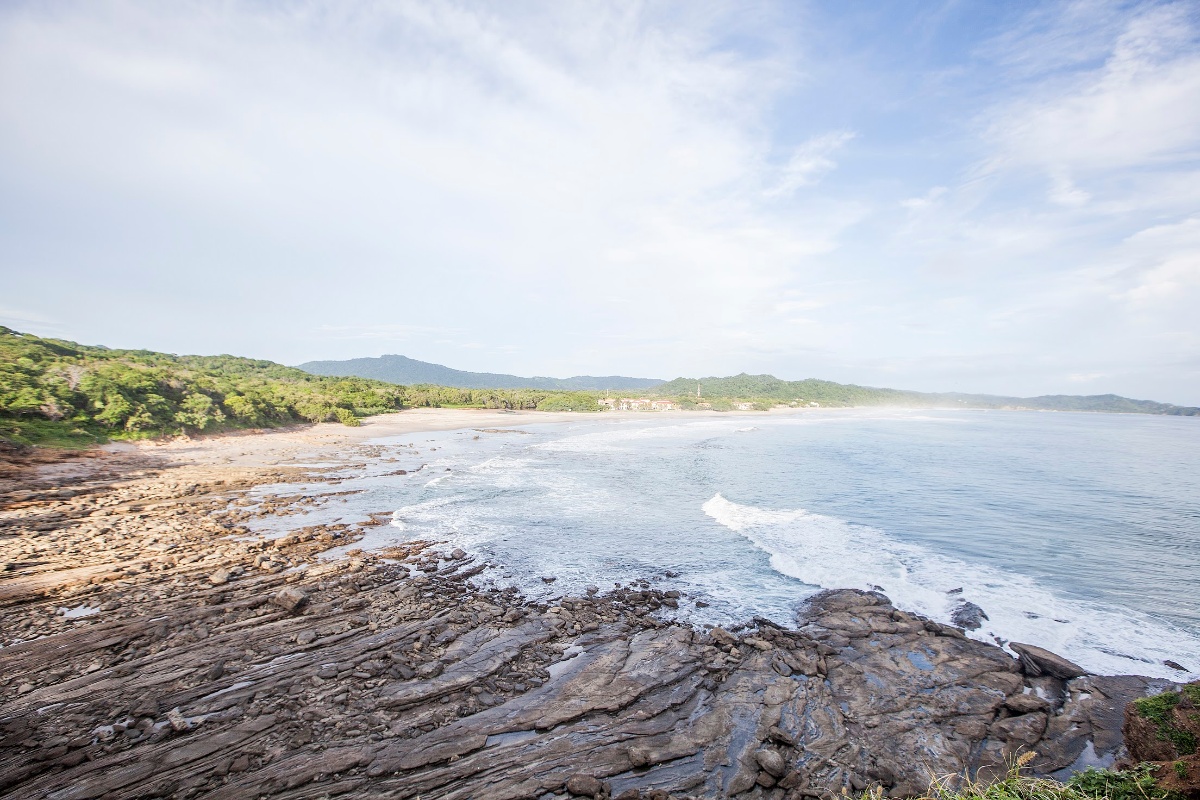 Playa Colorado rocky coastline with Pacific waves crashing against volcanic rock formations