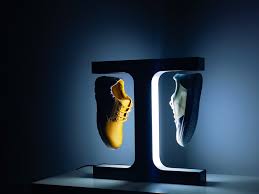 FLOAT GRAILS dual levitating sneaker display with gold and white sneakers illuminated by LED light