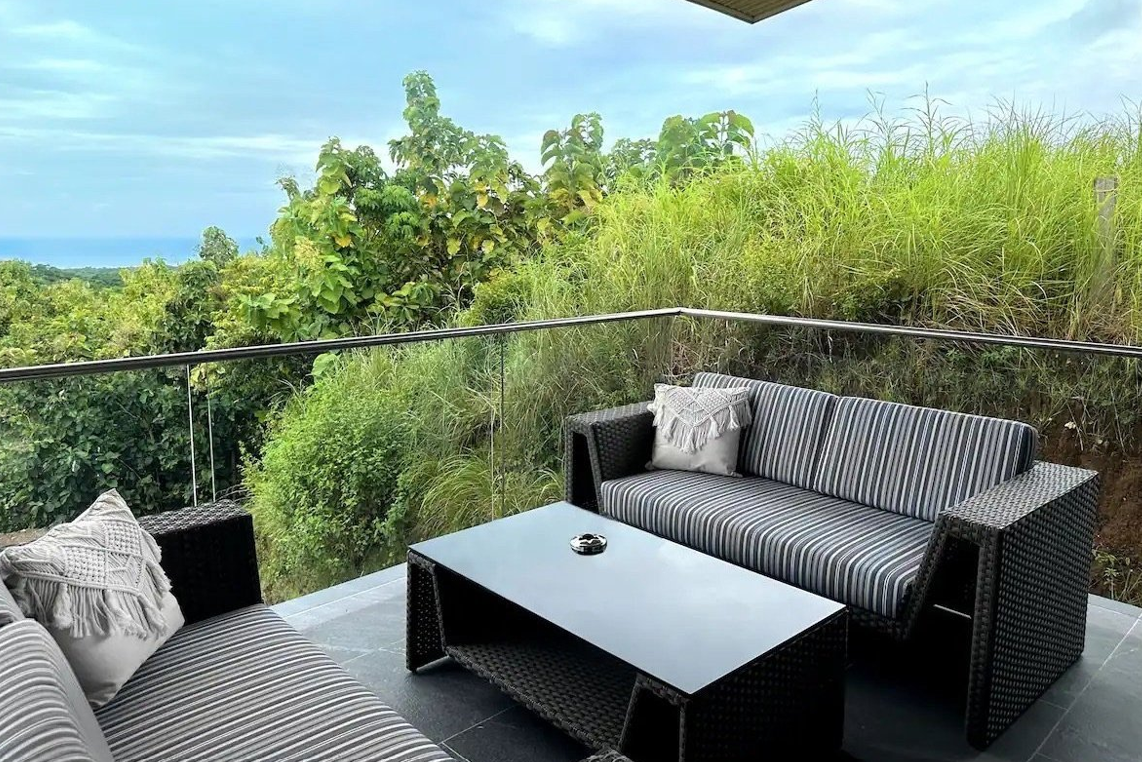 Horizon Suite — private balcony lounge with jungle and ocean view