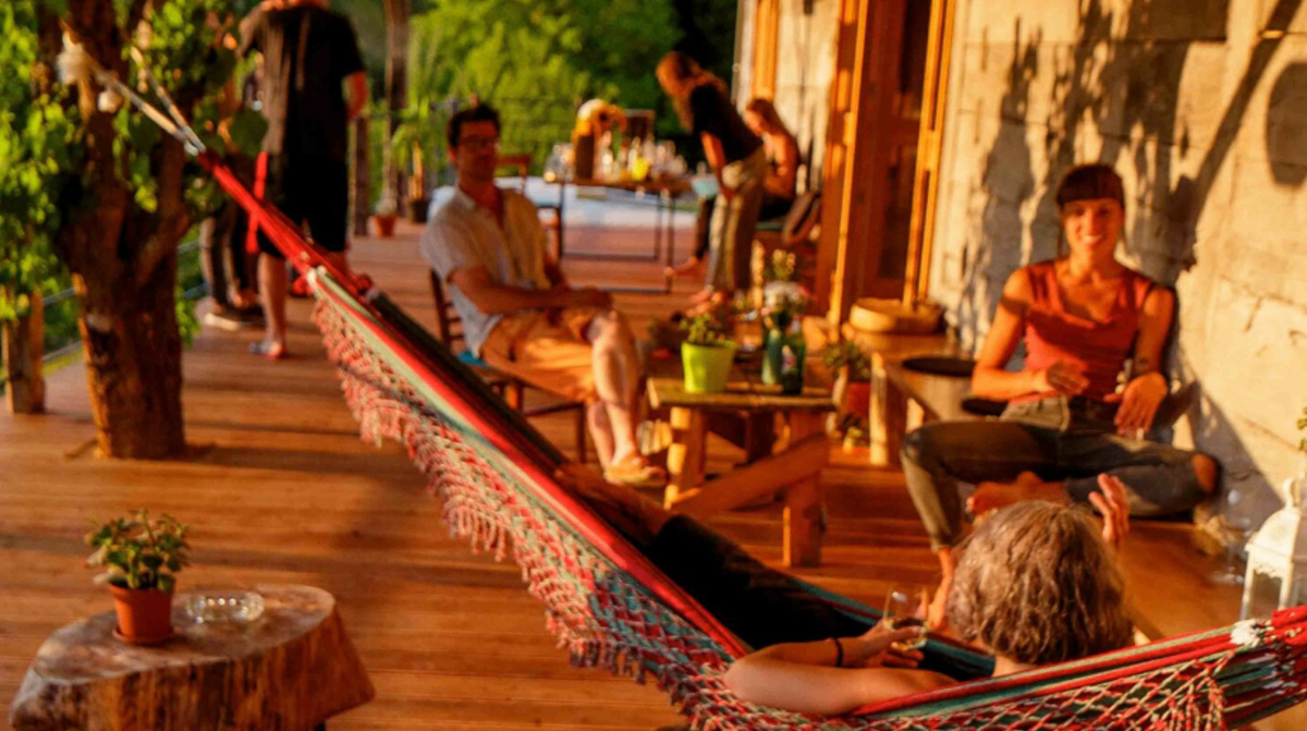 Retreat outdoor terrace with hammock and guests relaxing