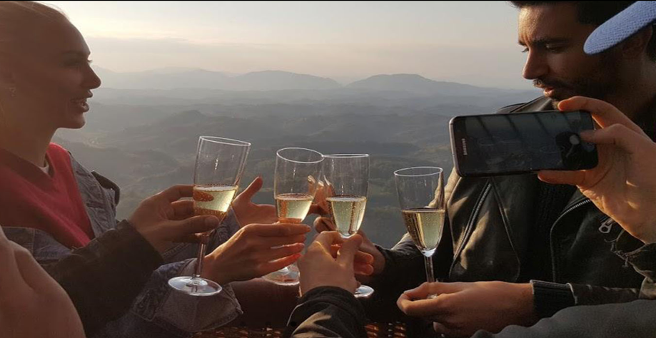 Friends toasting with champagne glasses overlooking mountain landscape