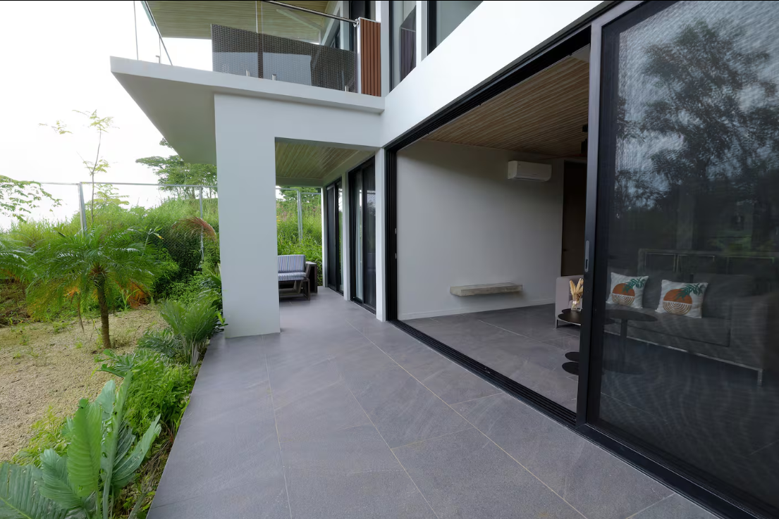 Garden Suite — private terrace with floor-to-ceiling sliding doors and lush garden