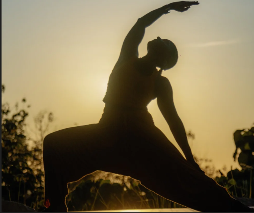 Yoga warrior silhouette at golden sunset - Blue Zone Retreat Costa Rica