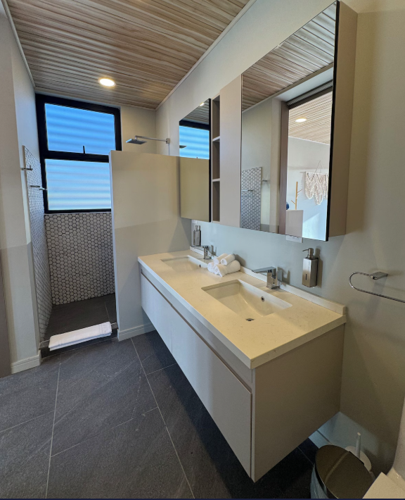 Garden Suite — en-suite bathroom with double vanity, hex tile walk-in shower and slatted wood ceiling