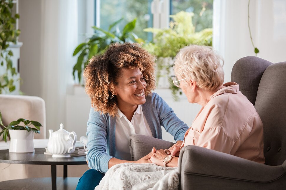 Professional caregiver assisting senior in Michigan home