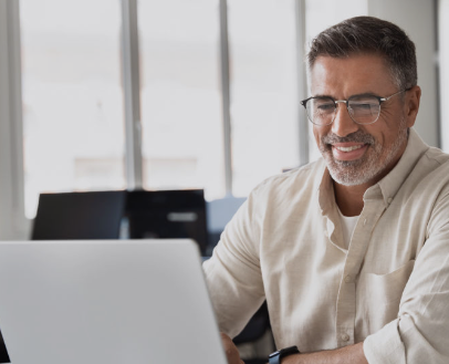 Two professionals collaborating with separate laptops