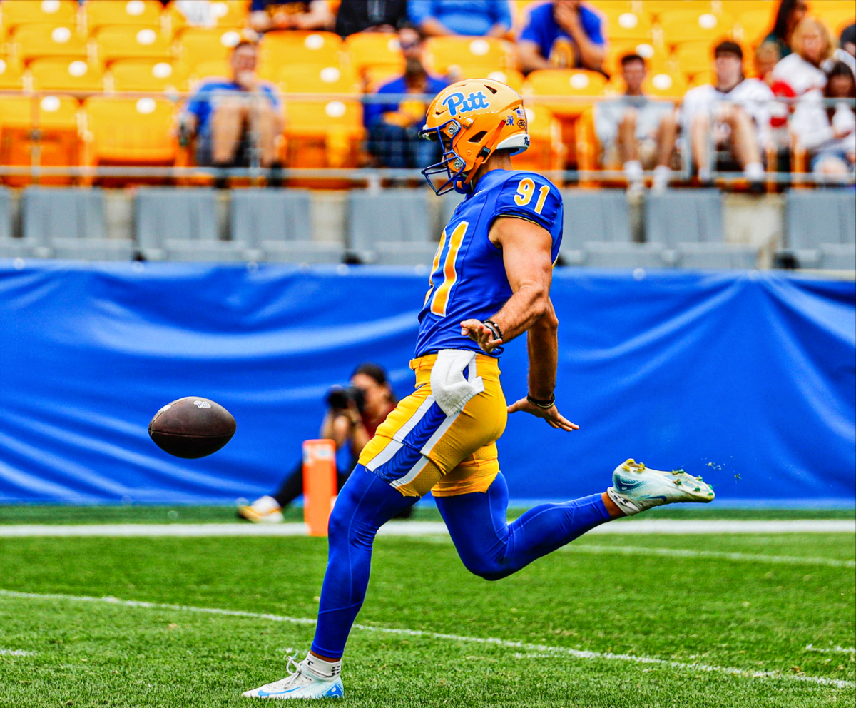 Caleb Junko #91 punting at University of Pittsburgh