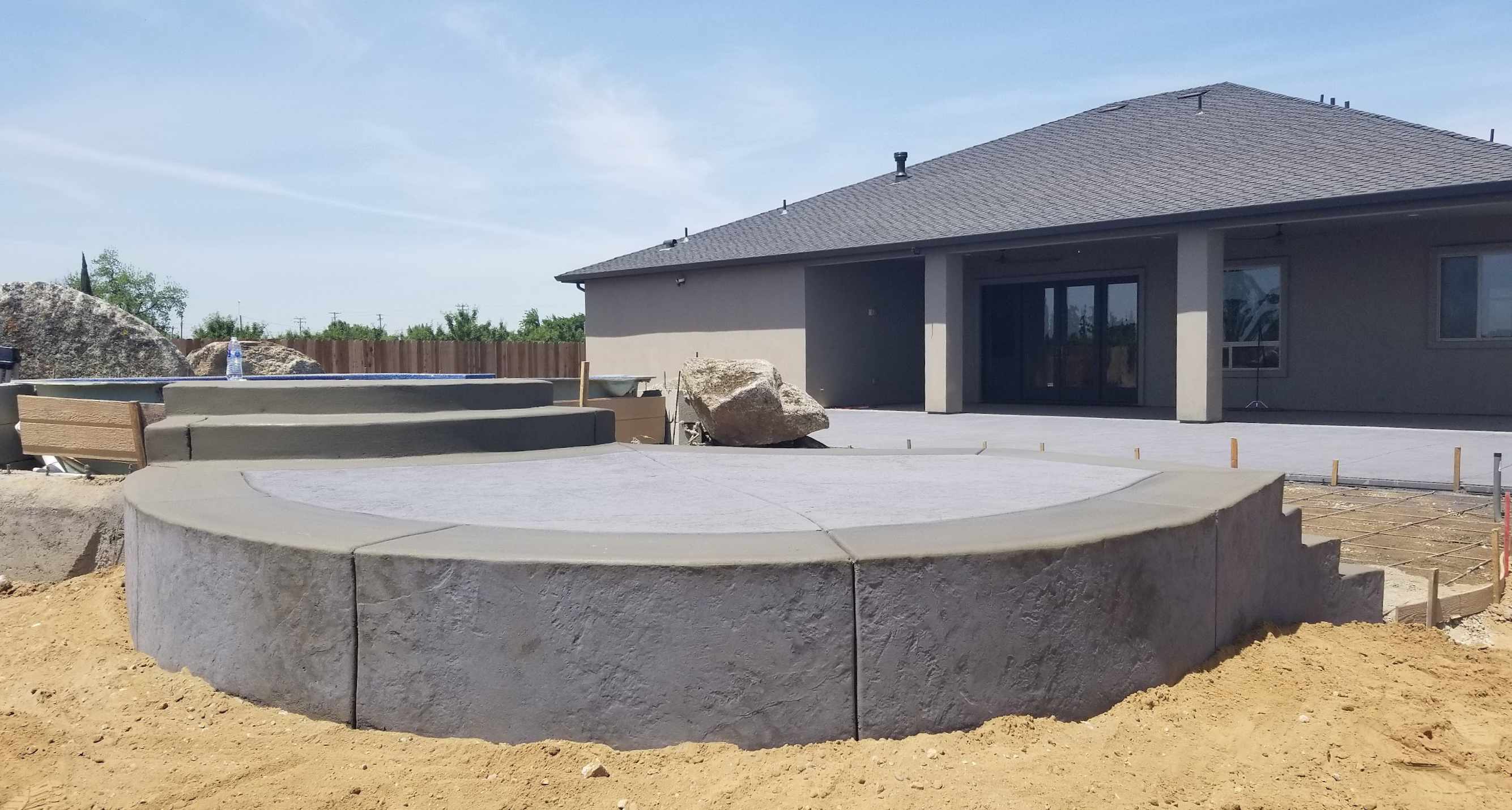 Concrete fire pit with circular pad and stepping stones in Manteca, CA