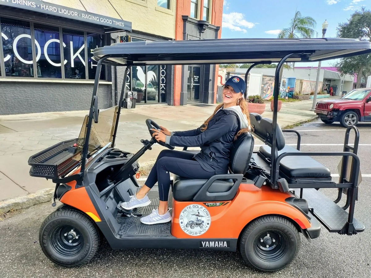 Customer on orange Yamaha golf cart in St. Pete