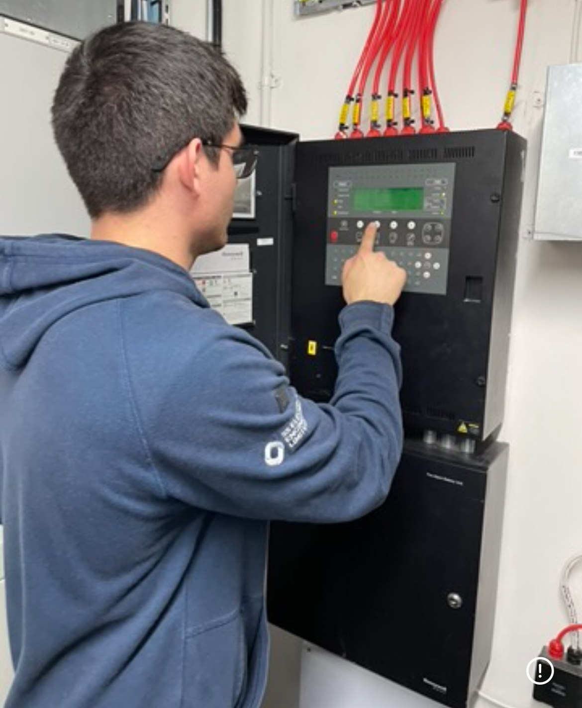 Commercial fire alarm control panel installed in a UK office building