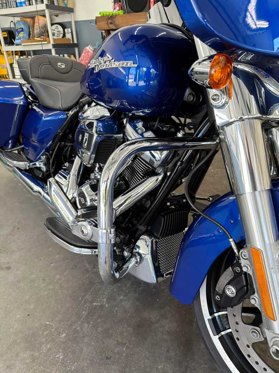 Blue Harley-Davidson motorcycle with professional detailing showing glossy paint and polished chrome