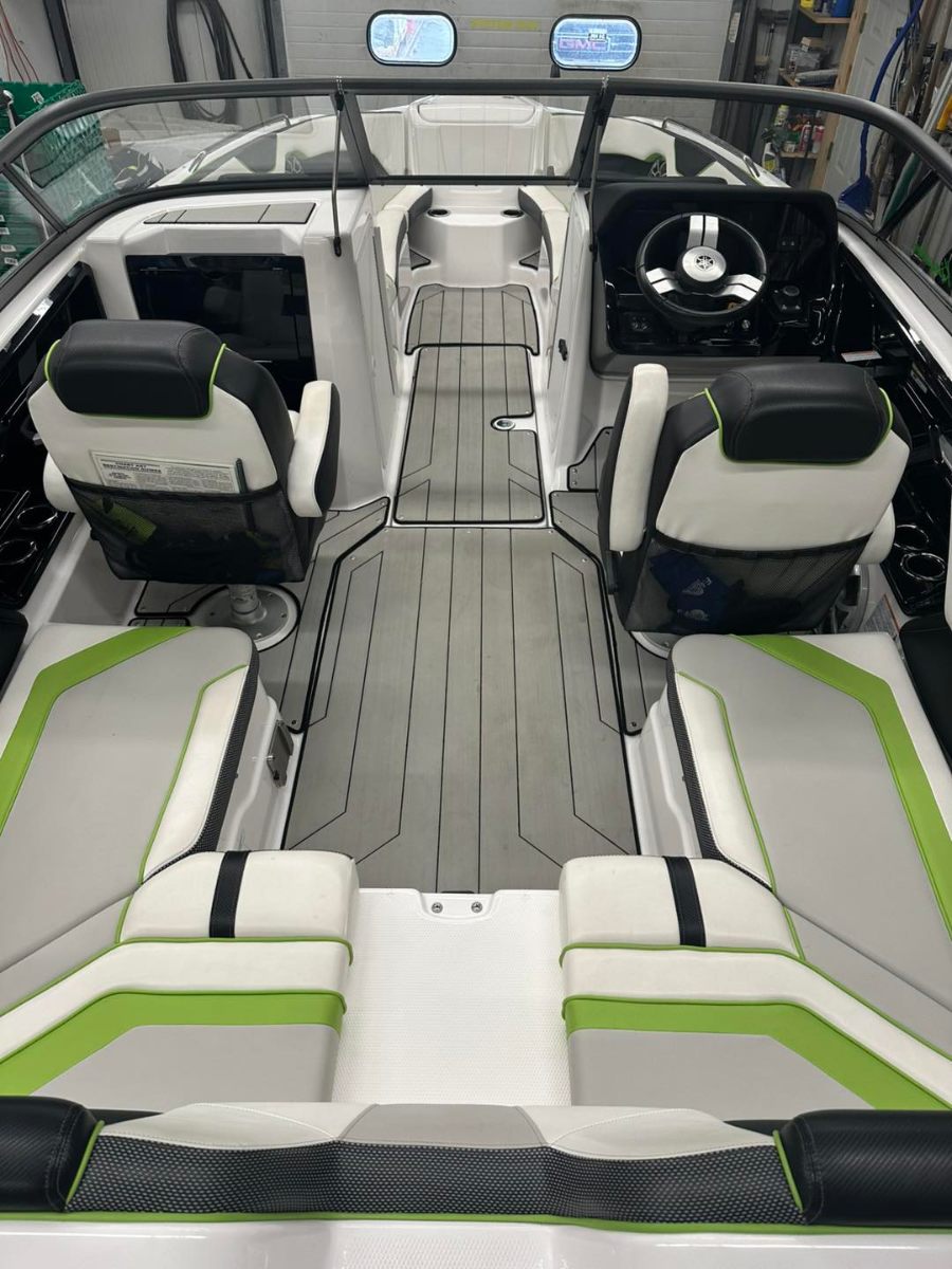 Yamaha boat interior detailing with pristine white and green upholstery and clean deck