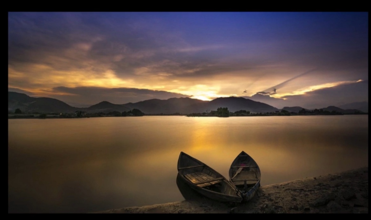 Person rowing boat across river