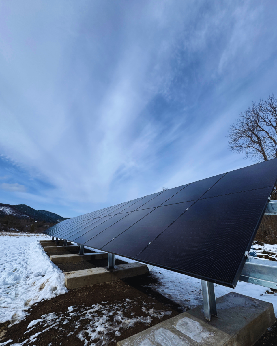 Ground mount solar panel installation with mountain view in winter