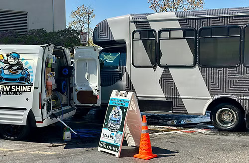 Professional automotive detailing specialist working on luxury vehicle paint correction and ceramic coating in modern Glen Burnie Maryland facility showing expert craftsmanship