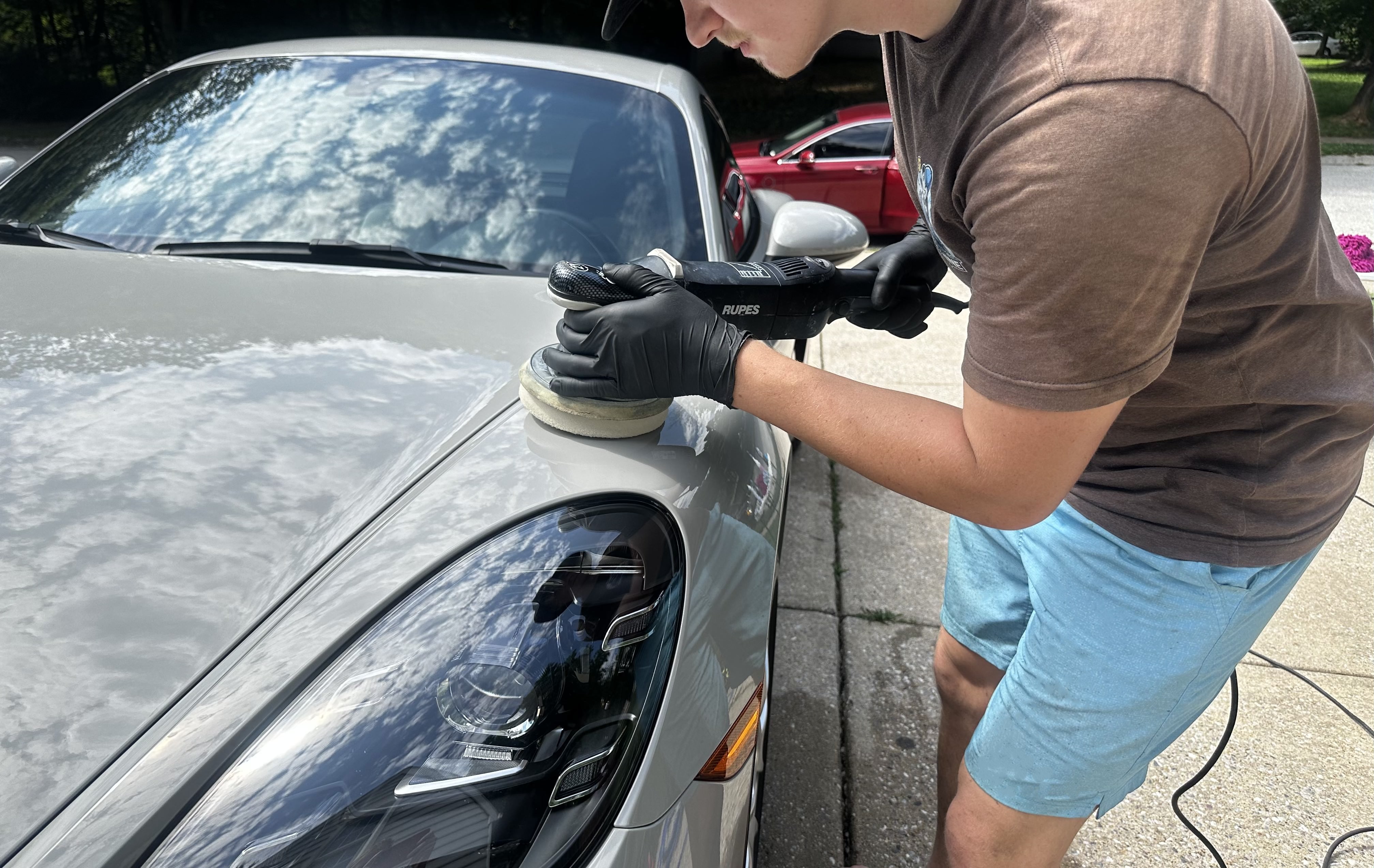 Professional paint correction process removing swirls and scratches from luxury vehicle paint in Glen Burnie Maryland detailing facility