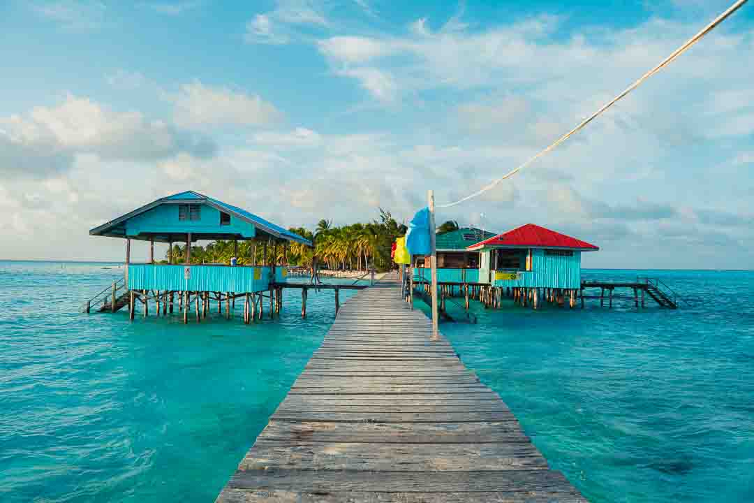 Wooden pier leading to over-water cottages in Balabac