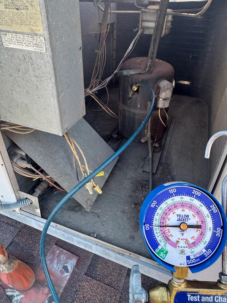 AC4LESS technician charging refrigerant on AC unit