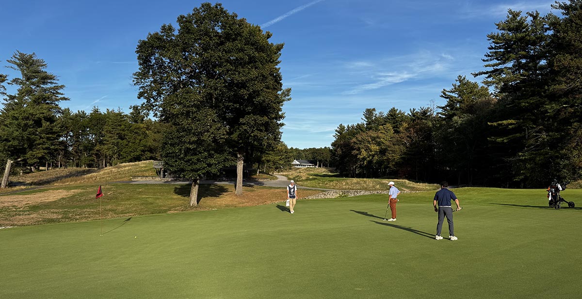 Caddy helping golfer at The Pines