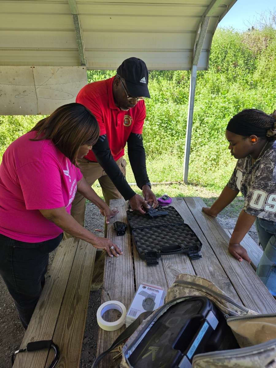 Chief Jacobs teaching firearm handling at the range table