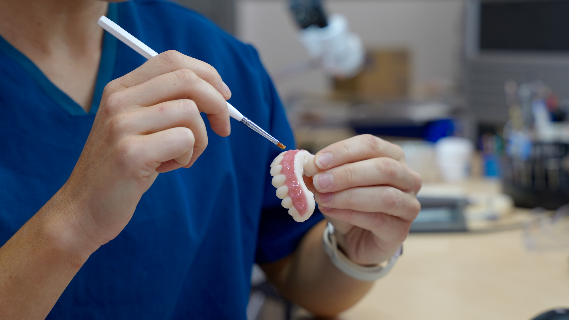 Ceramist crafting dental restoration