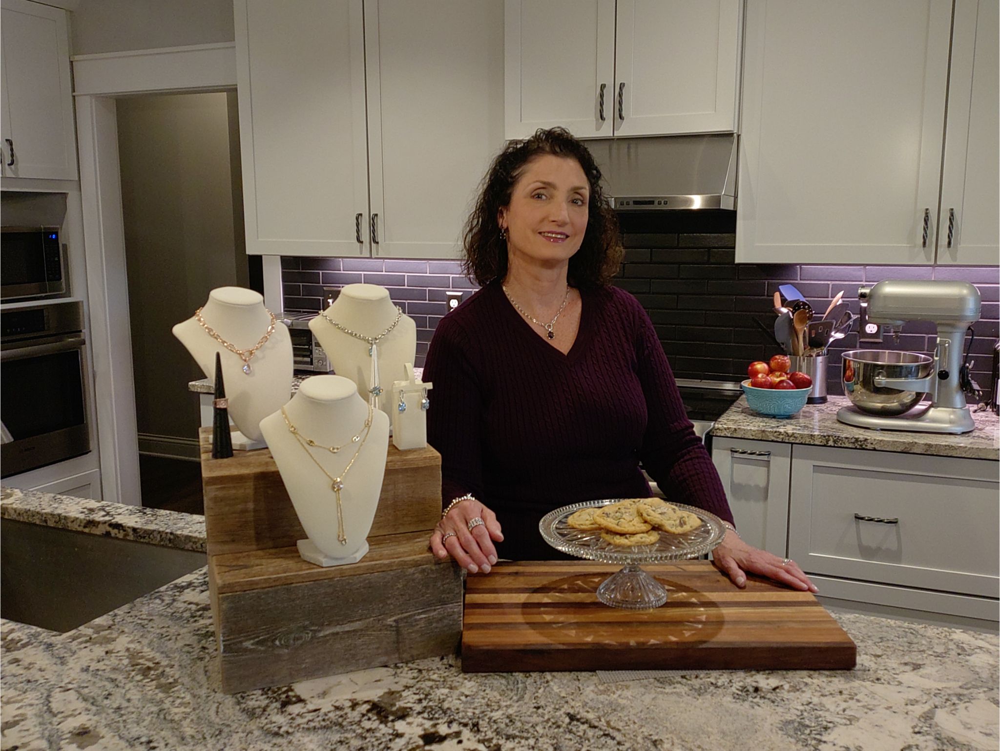 Heather Daugherty, Ohio Bomb Party host and BlingKitchen founder, in her home kitchen with jewelry and baked goods