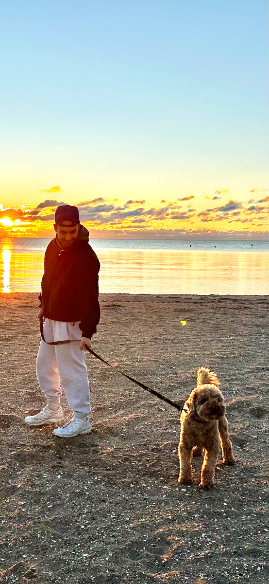 Pat at the beach with dog