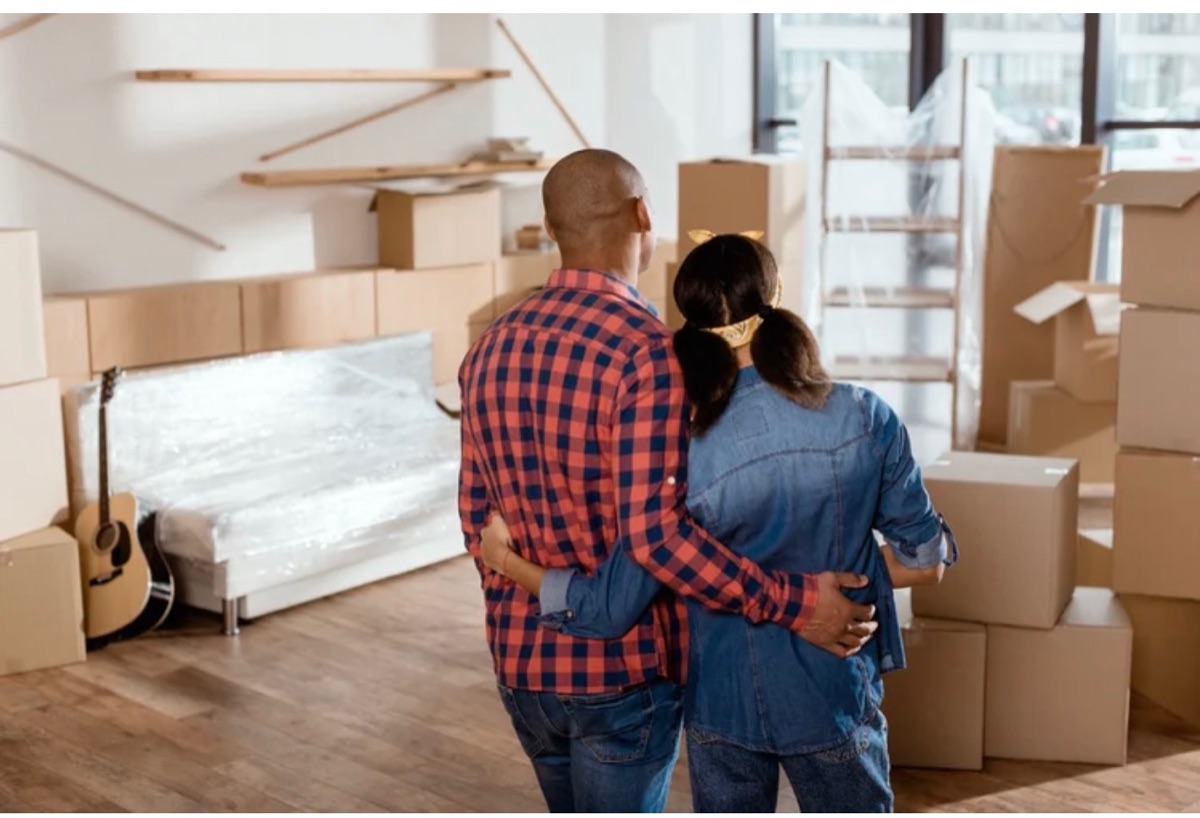 Couple moving into new home with boxes