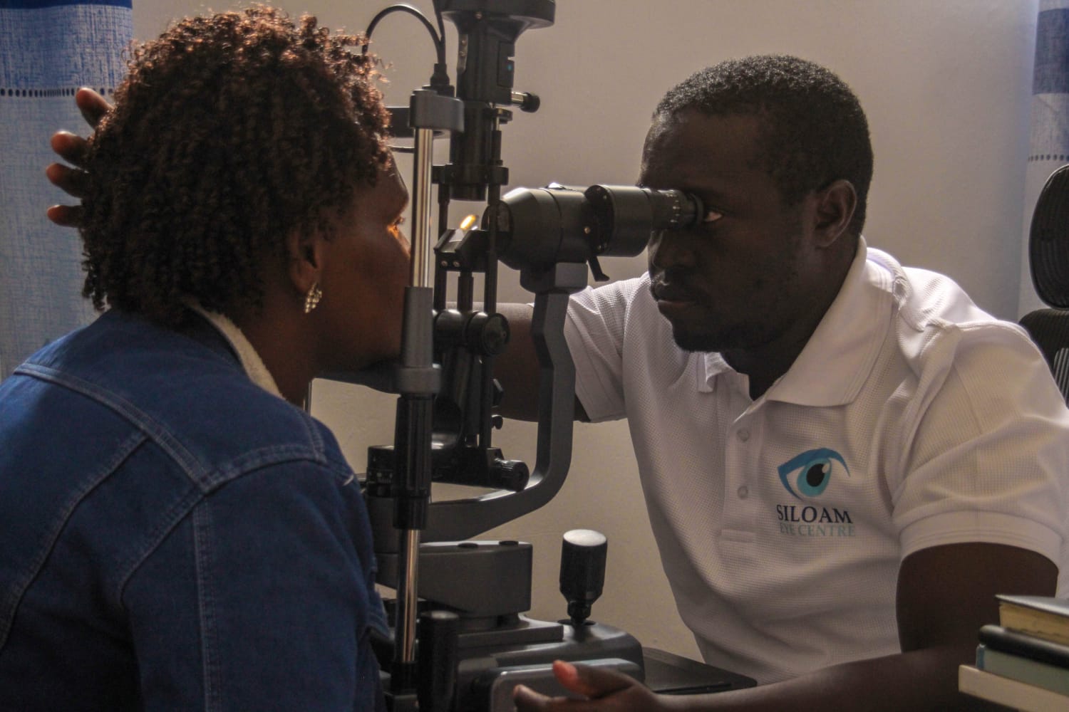 Professional eye examination being performed by an ophthalmologist at Siloam Eye Clinic in Eldoret Kenya using modern diagnostic equipment