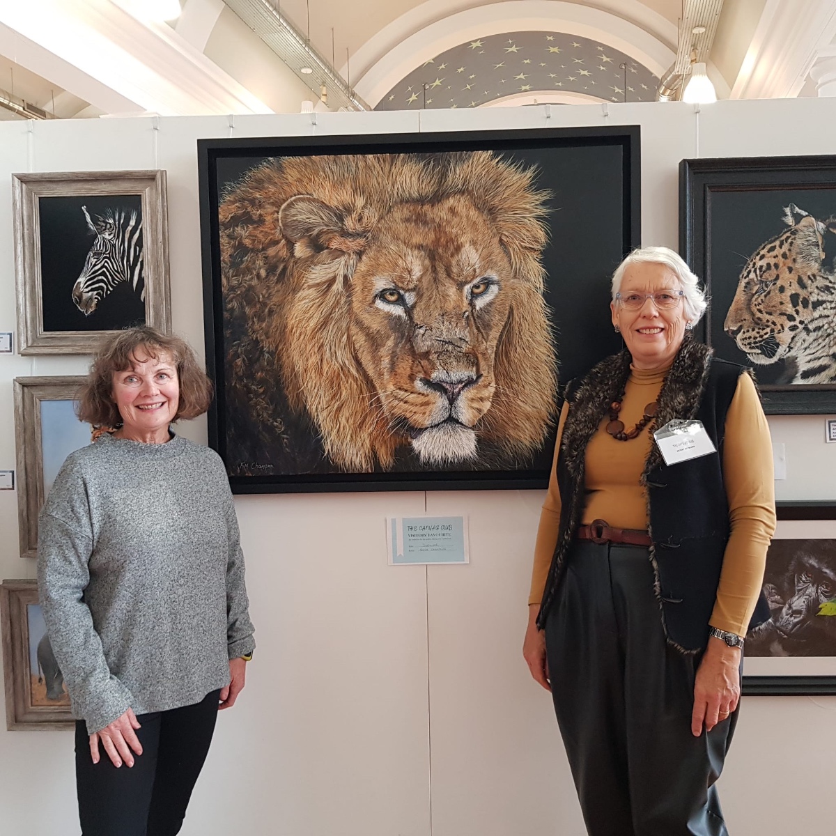 Fiona Champion with her award-winning lion painting at The Canvas Club exhibition