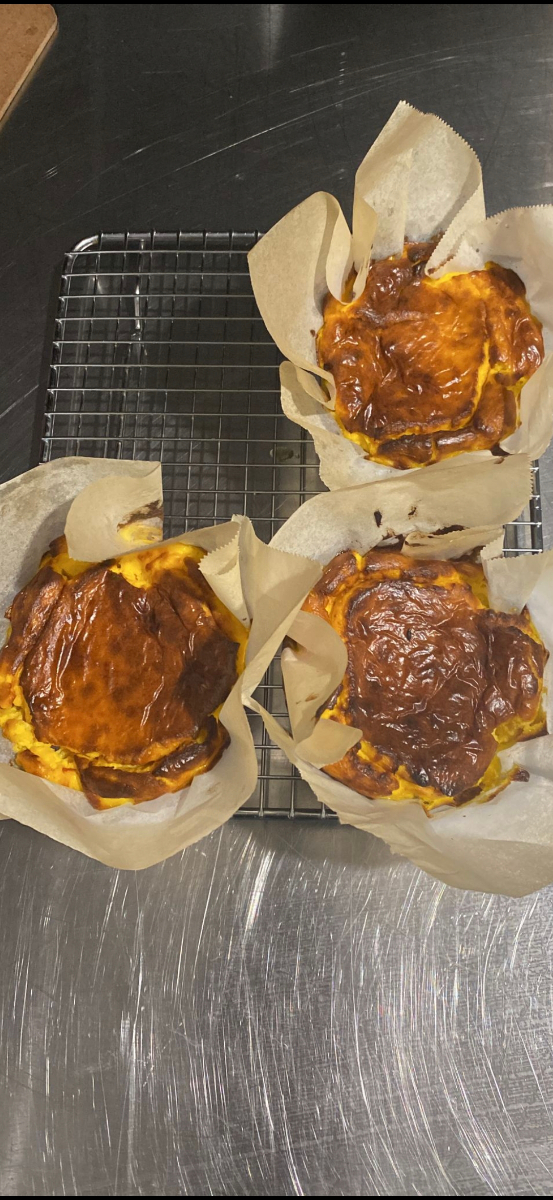 Freshly baked Basque cheesecakes cooling on a rack