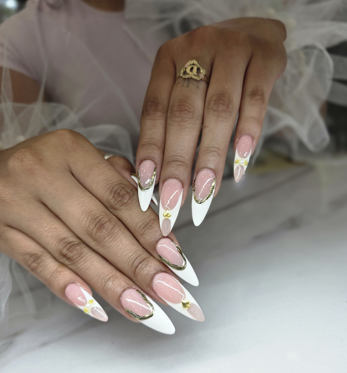 Stunning long stiletto nails with glamorous French manicure, golden details and elegant decorative elements