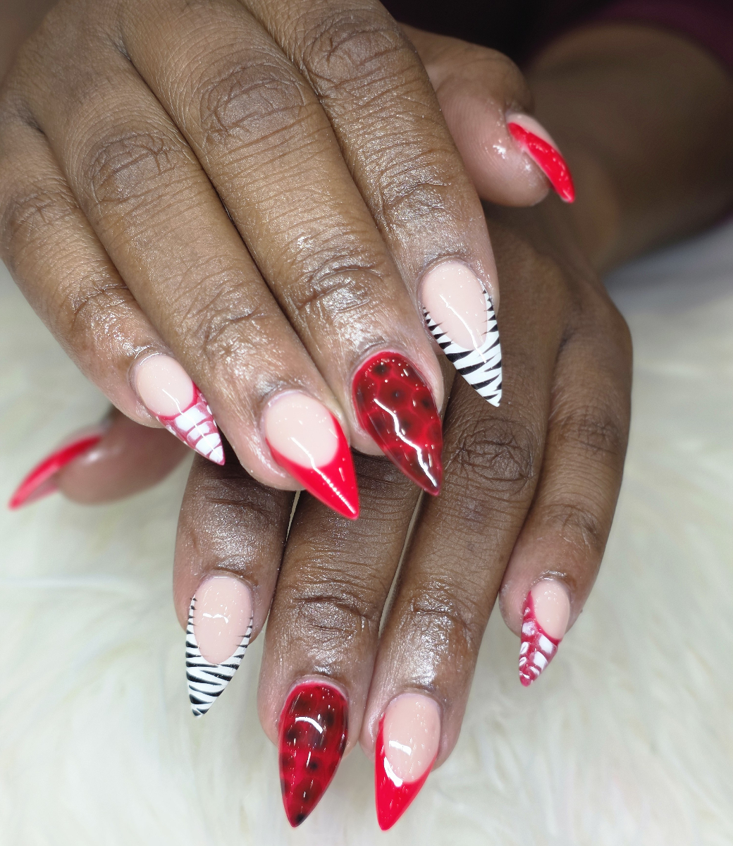 Vibrant nail art with red and black design featuring elegant geometric patterns and professional detailing