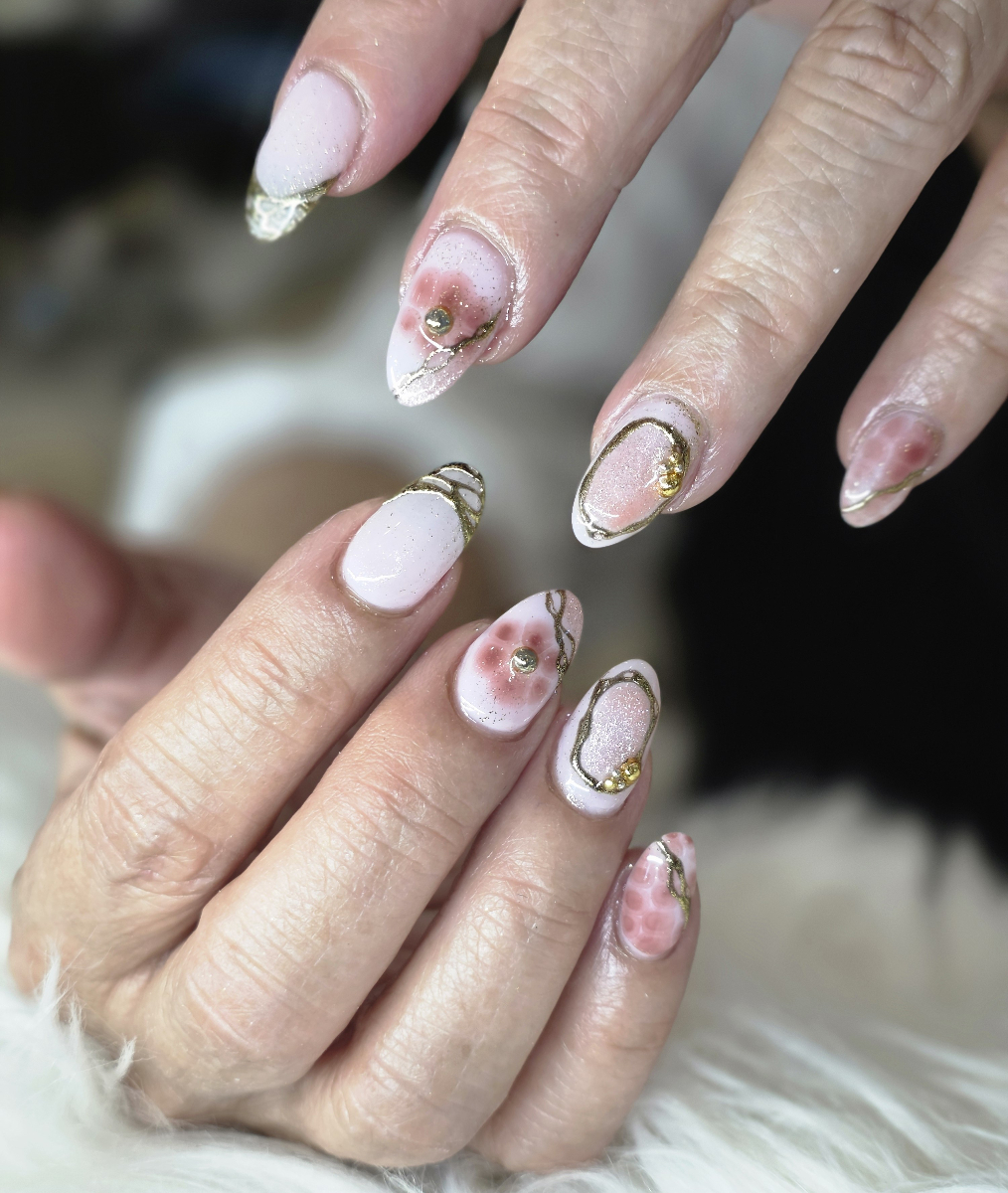 Spectacular nail art with brilliant golden metallic effects and elegant decorations showcasing premium artistry