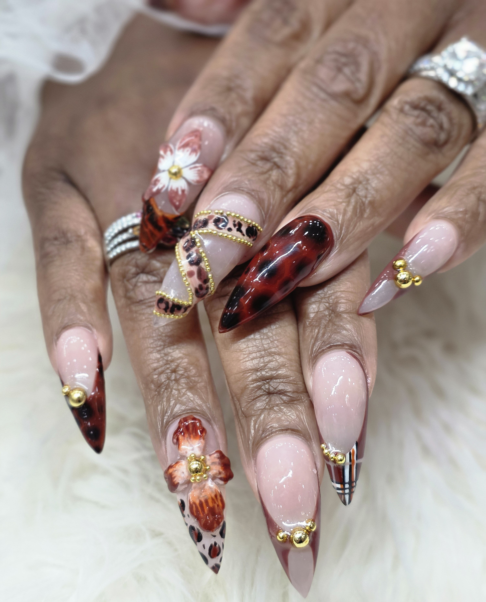 Spectacular nail art with brilliant metallic effects, golden decorations and sophisticated design showcasing premium techniques