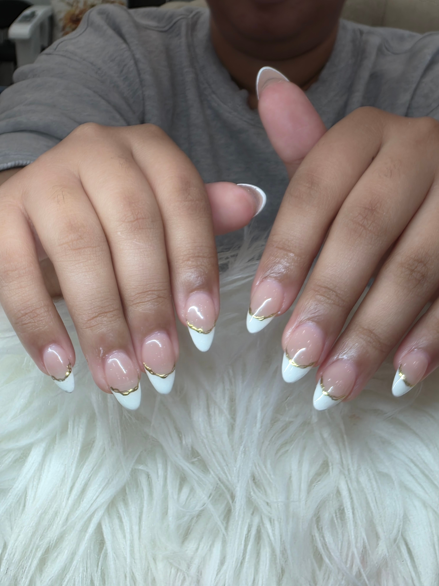 Elegant French manicure with delicate golden details and professional finish showcasing classic sophistication