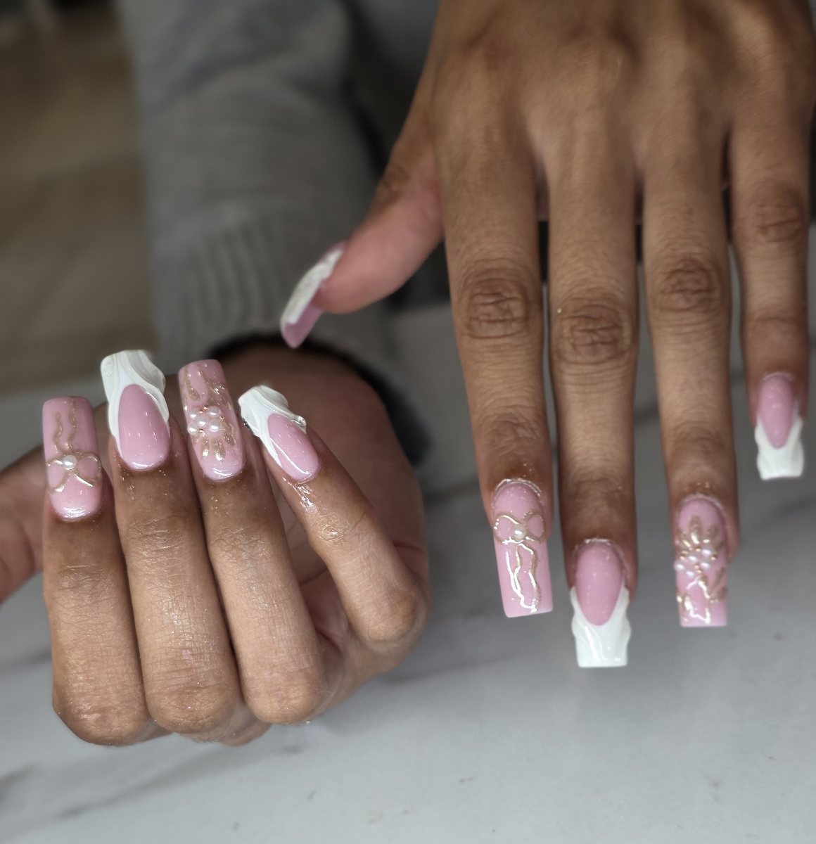 Beautiful French manicure with pink base and white tips featuring elegant nail art details and professional salon quality
