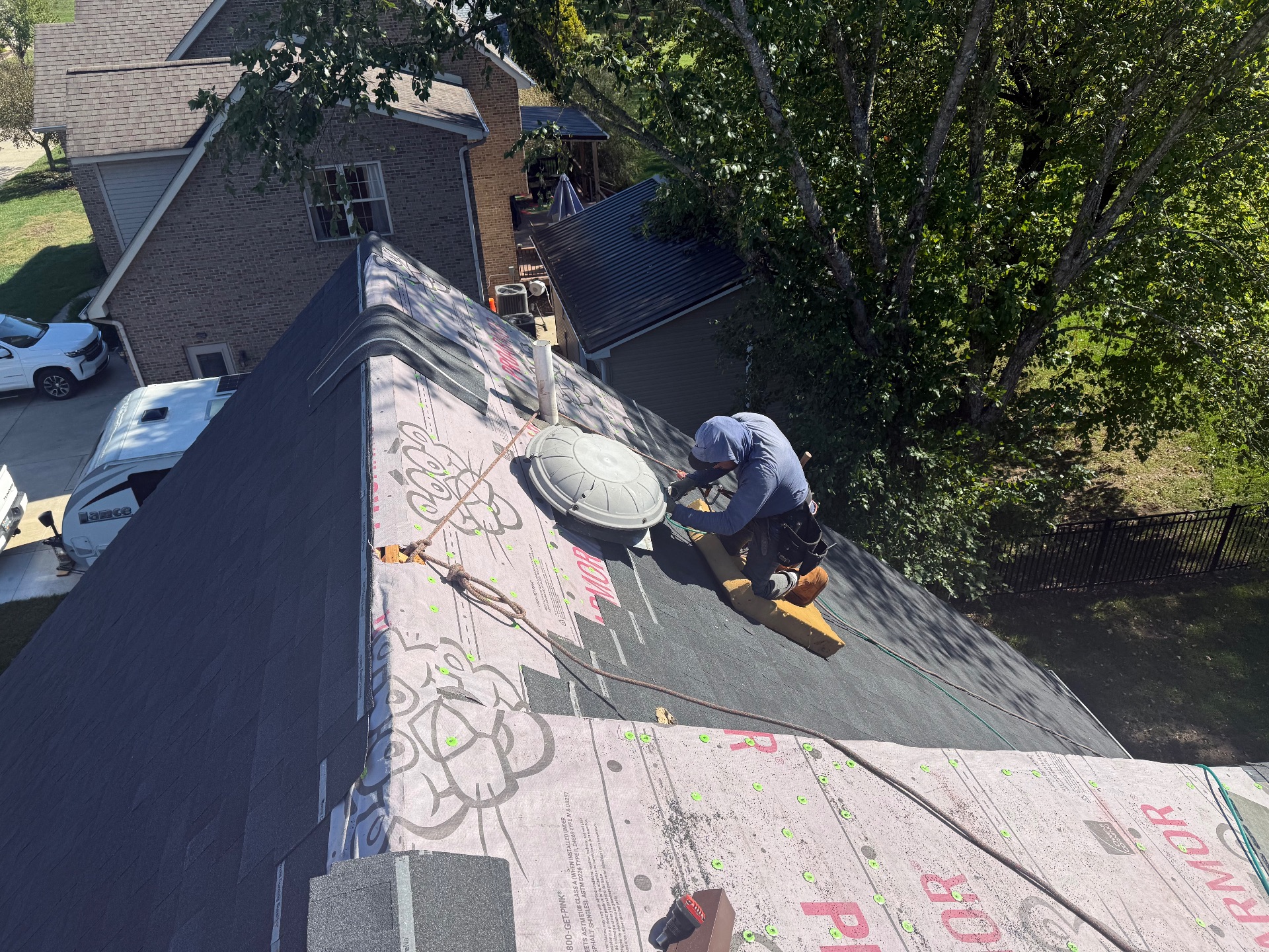 Roofer installing architectural shingles