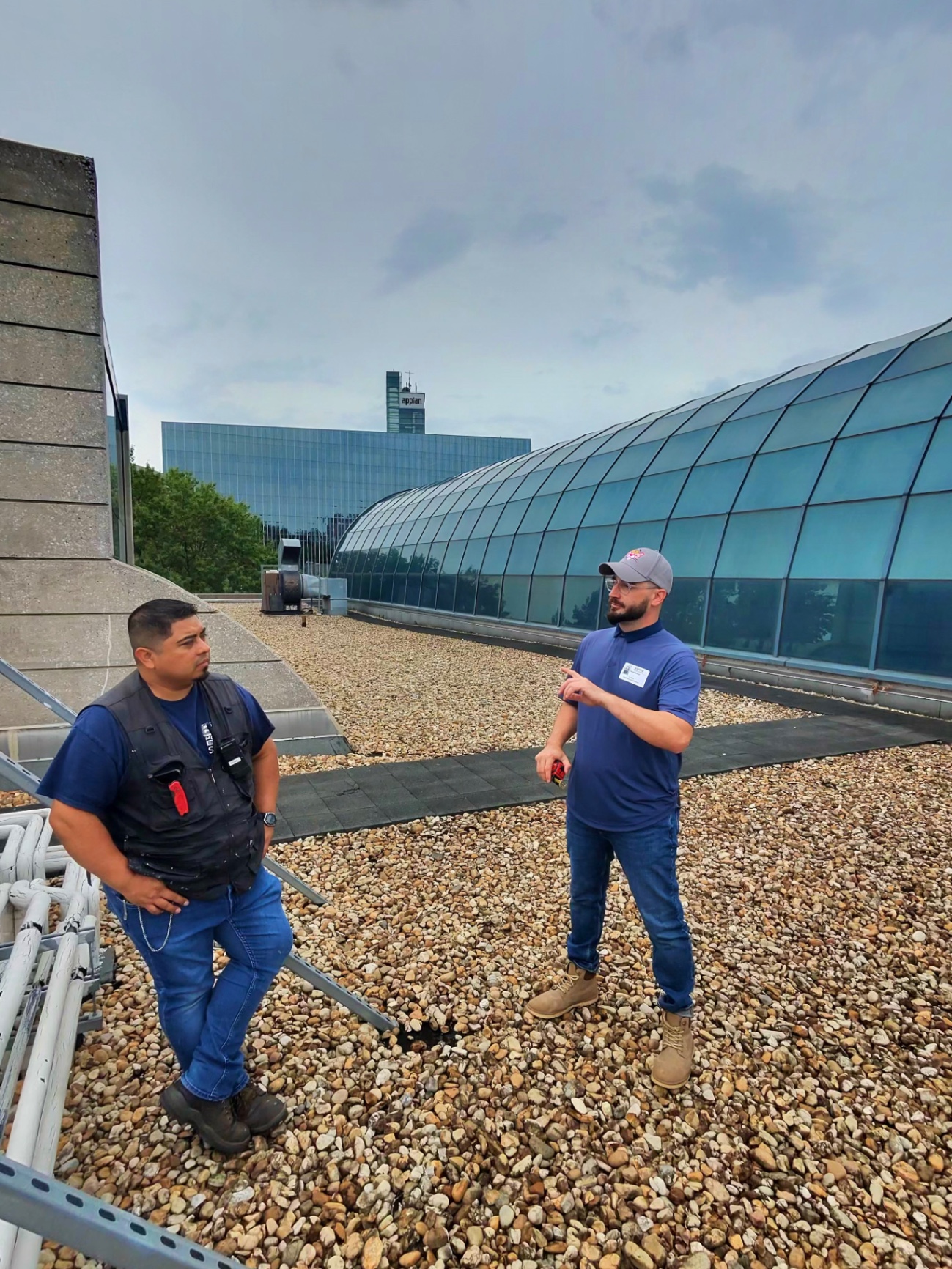Two professionals on flat commercial rooftop