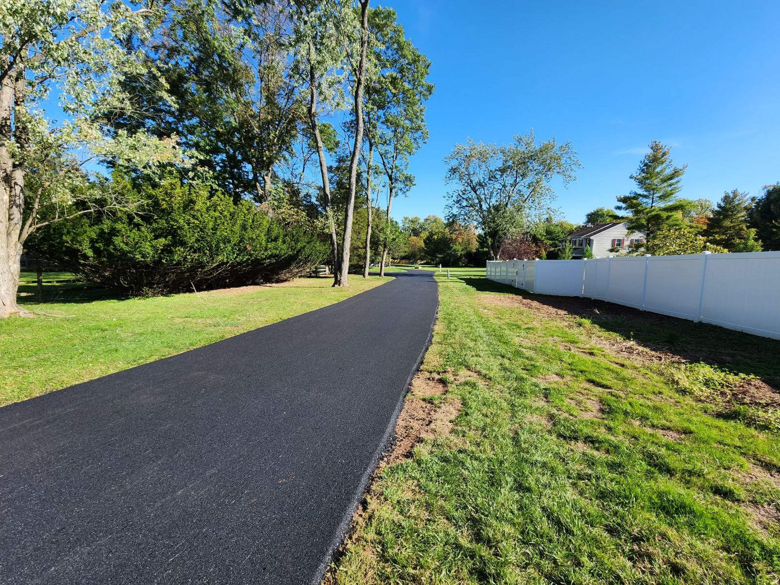 Professional paving crew with large equipment installing a residential driveway in Pennsylvania