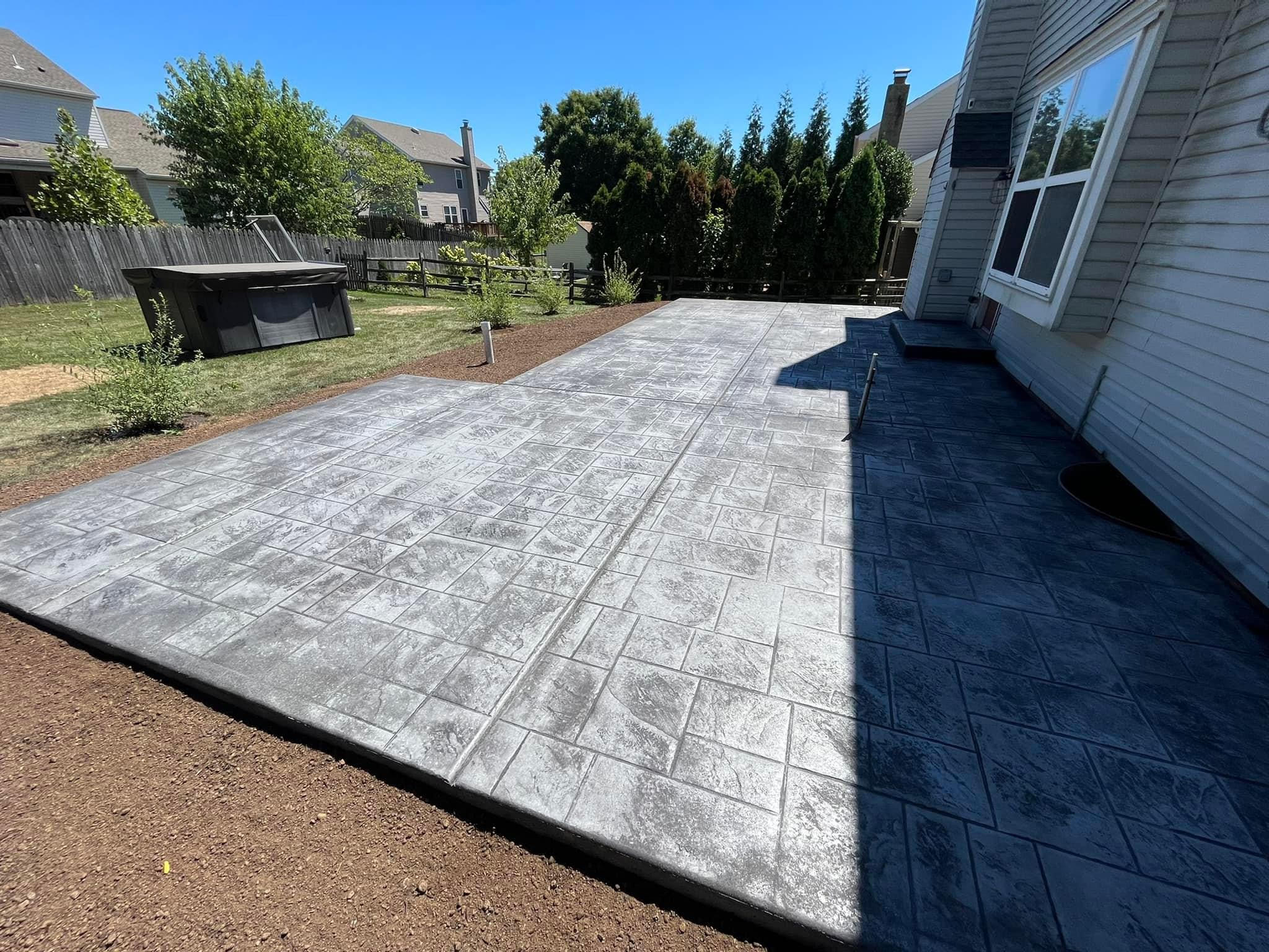 Beautiful stamped concrete patio with ashlar slate pattern in a Pennsylvania residential backyard