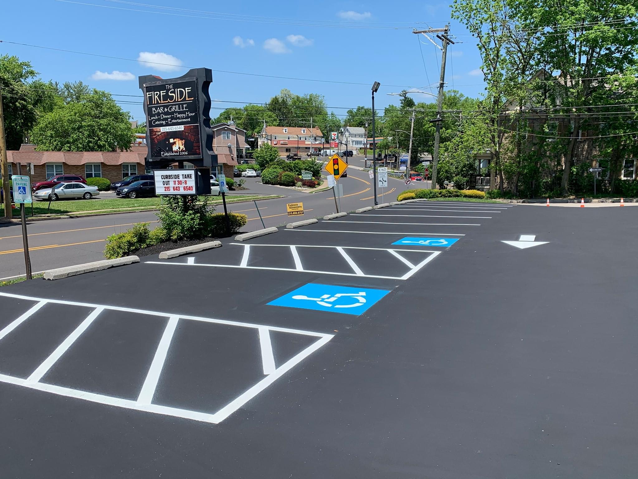 Commercial asphalt paving crew at work on a retail center parking lot transformation project in Newtown Pennsylvania
