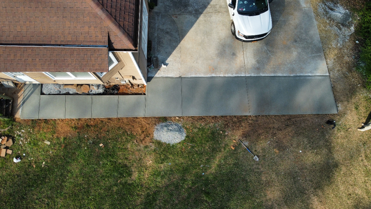 Aerial view of concrete driveway and sidewalk extension in Loganville GA by Greenstone Landscaping