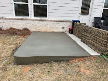 Freshly poured concrete patio slab by Greenstone Landscaping in Lawrenceville GA