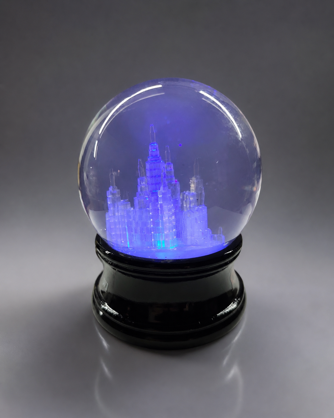 Custom snow globe featuring a clock tower courthouse with an antique brass engraved base and architectural detail