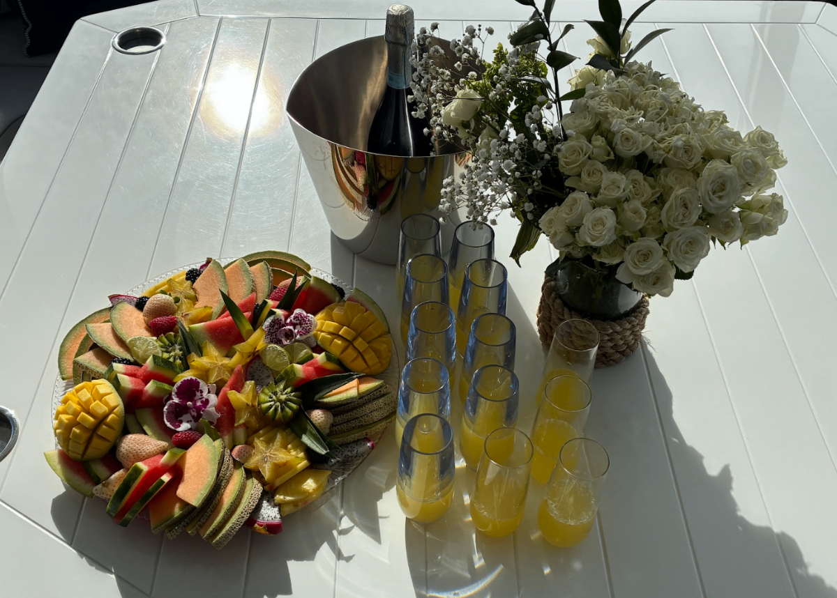 Champagne and fruit spread on board