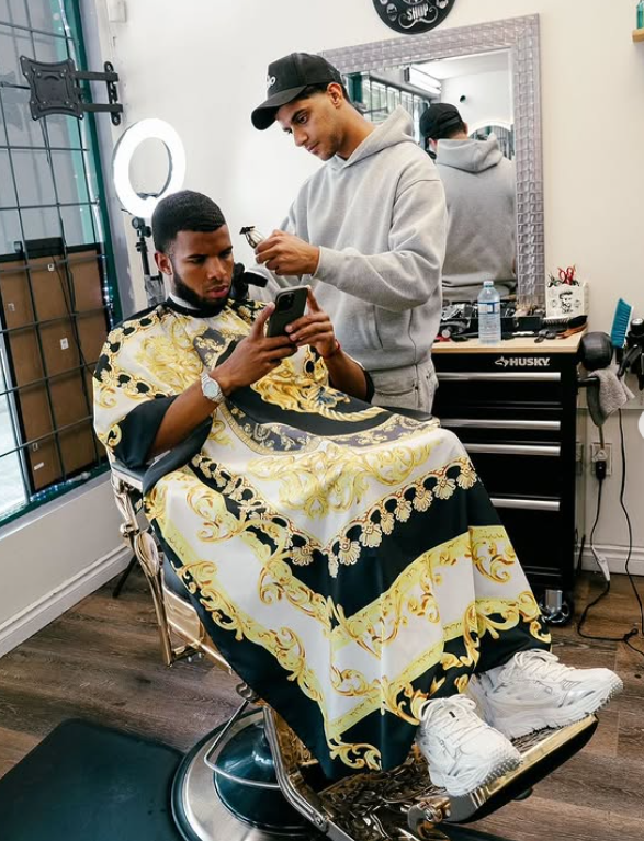 Barber working on client