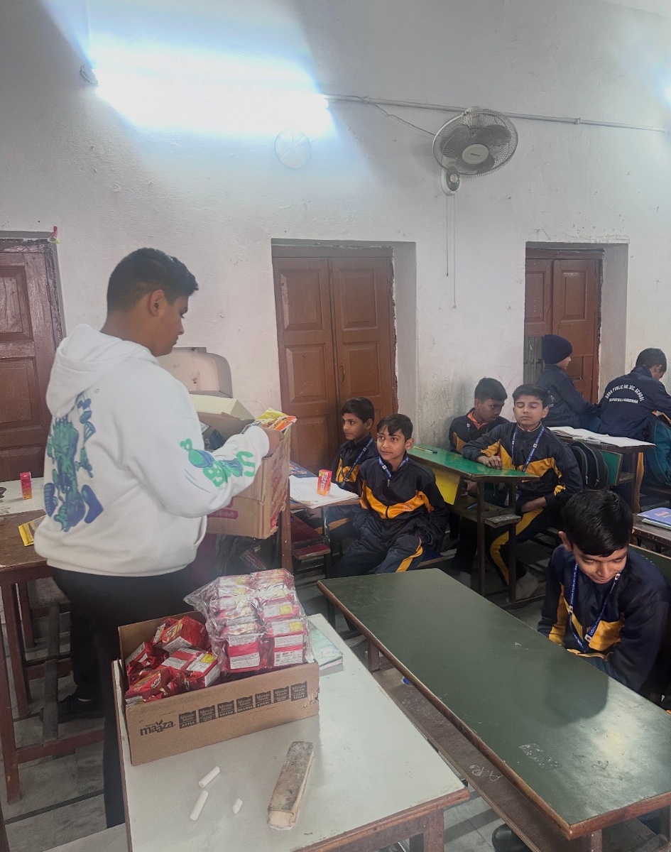 Distributing supplies to students in classroom at Doon Public School