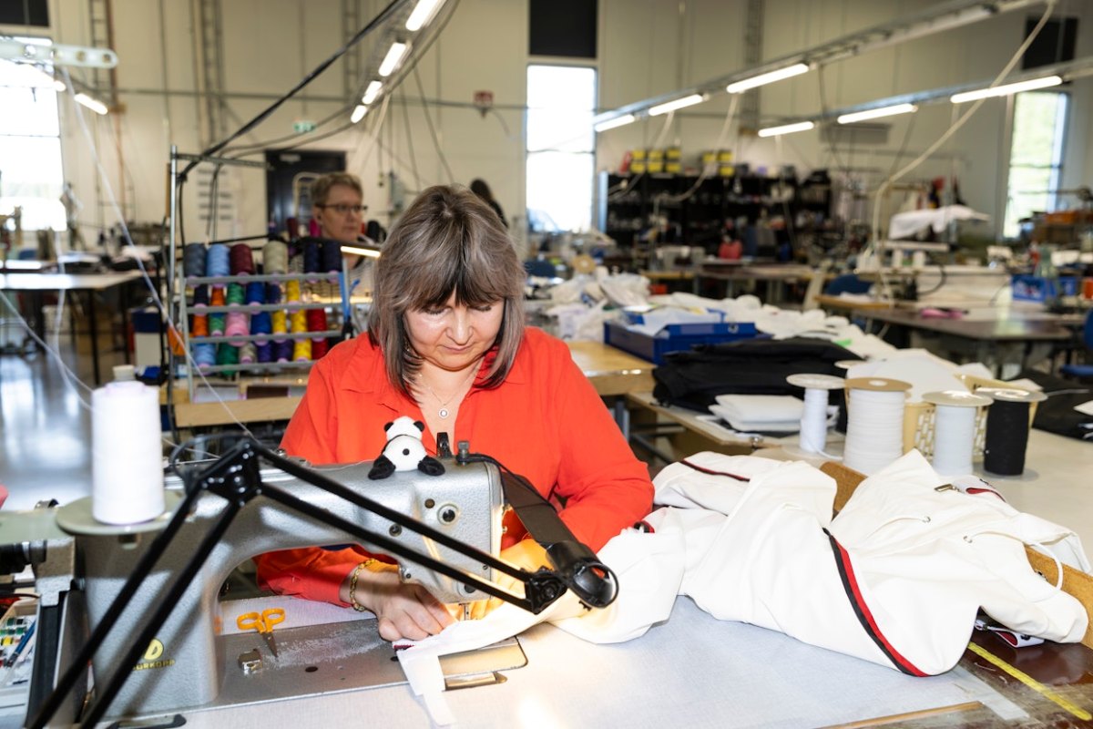 Kvinne som syr på Miras fabrikk