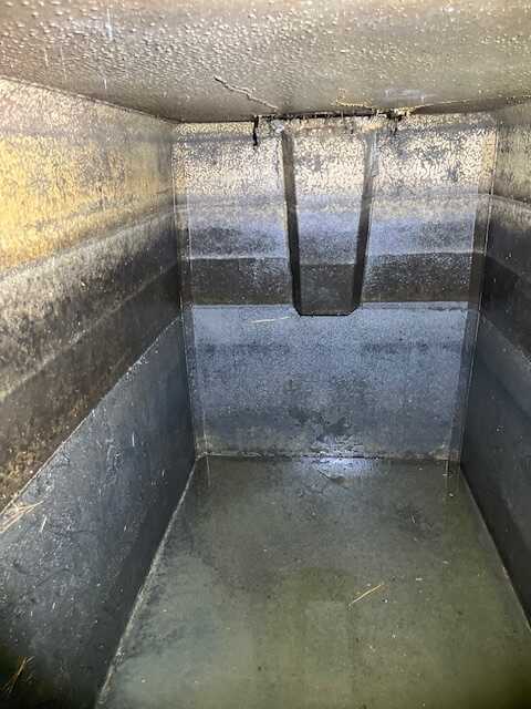 Interior view of a septic tank showing the baffle and tank walls during a septic inspection in Rock Hill SC